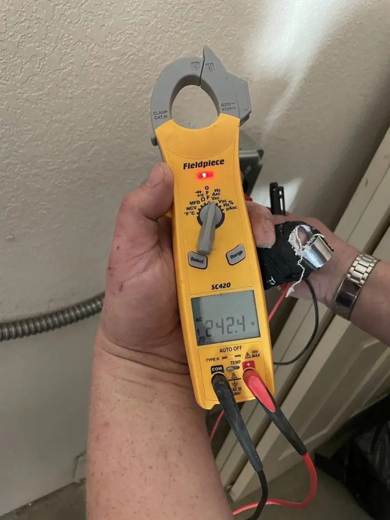 Voltage testing with clamp meter during Recessed Lighting Installation in Maurice